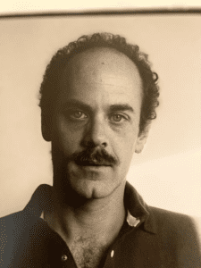 A black and white portrait of the author Robert Glück