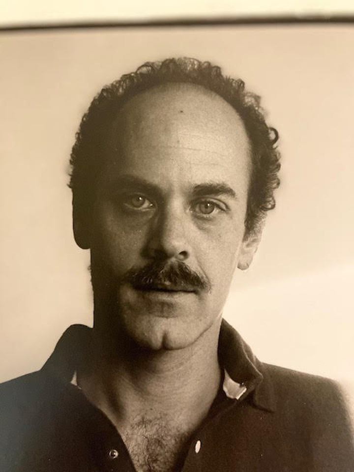 A black and white portrait of the author Robert Glück